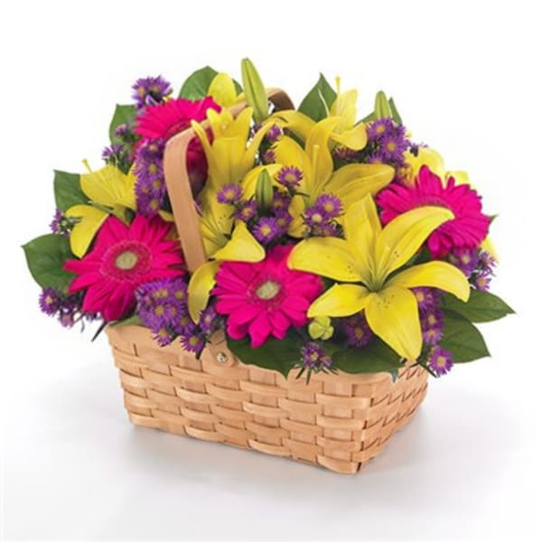 Basket of yellow lilies, pink gerbera daisies, and purple filler flowers