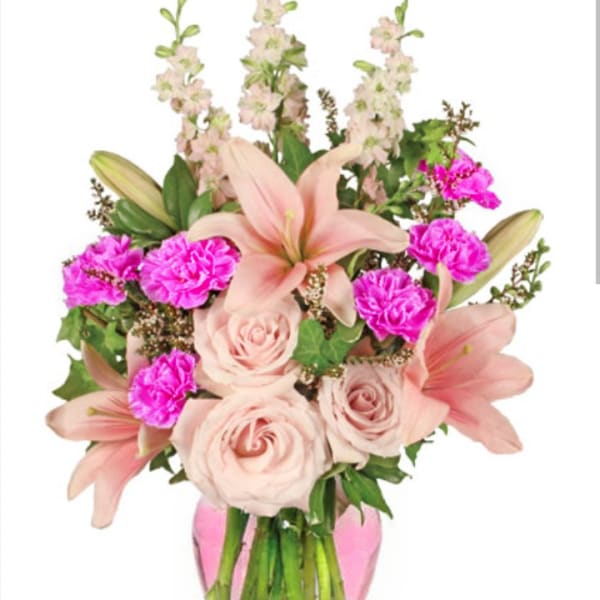 Pink lilies, roses, and carnations in a vase