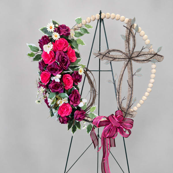 Floral heart wreath with pink and purple roses on a stand