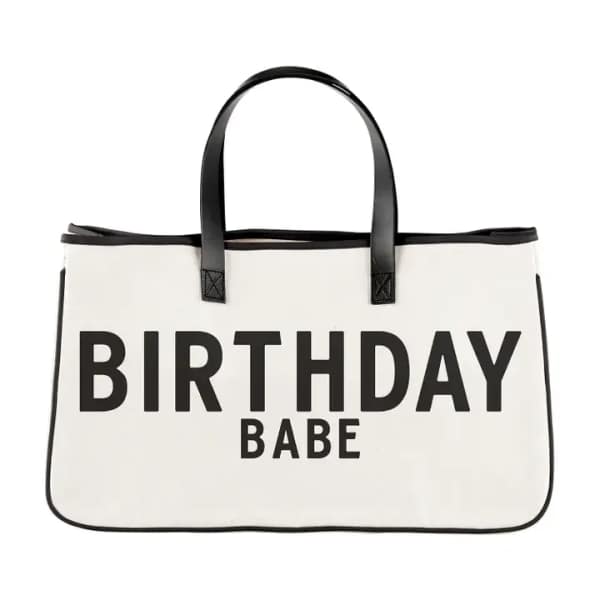 White tote bag with black handles and the words BIRTHDAY BABE