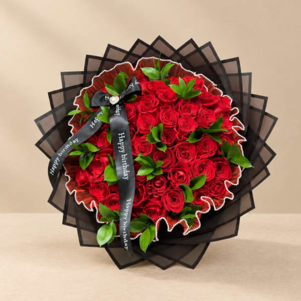Bouquet of red roses with green accents and a black birthday ribbon