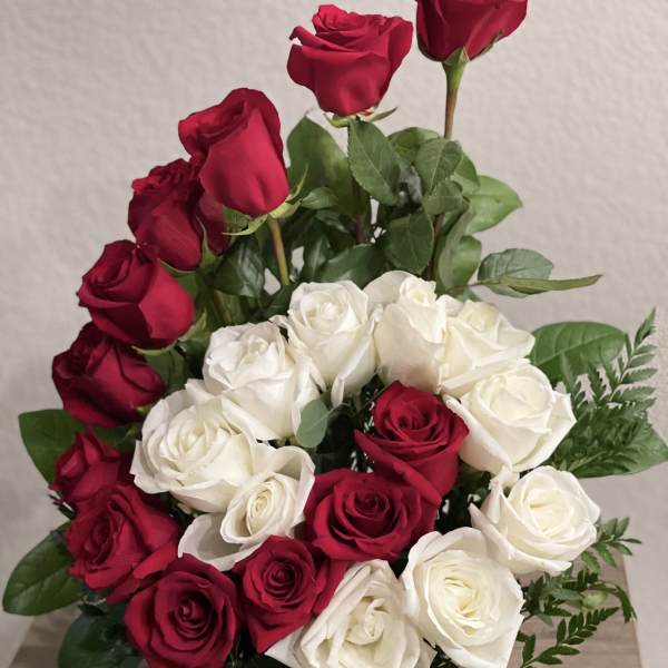 Bouquet of red and white roses with greenery
