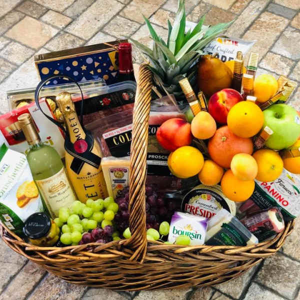 Gift basket with wine, fruit, cheese, and crackers