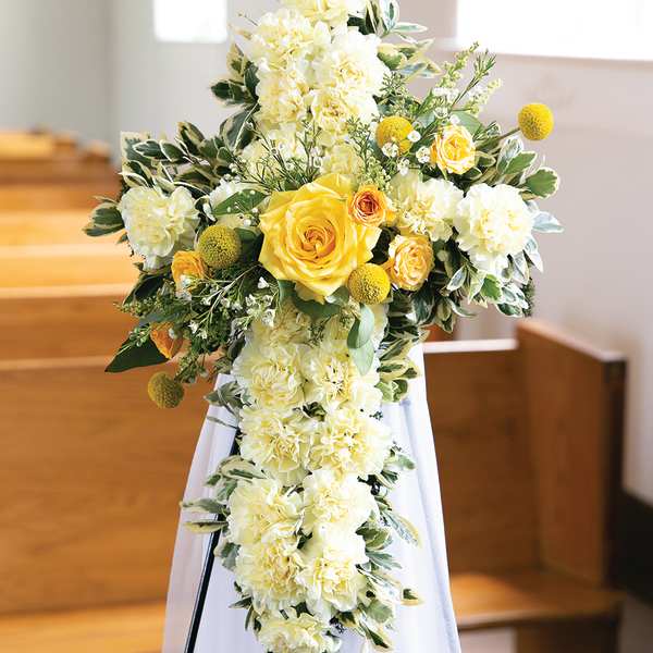 Yellow and white floral spray on a stand