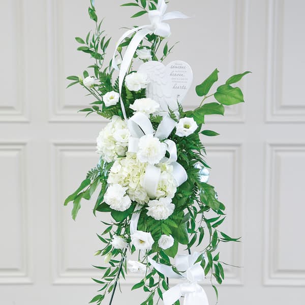 White sympathy standing spray with ribbon and heart plaque