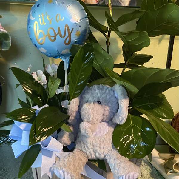 Blue boy balloon with a plush elephant in a wooden basket