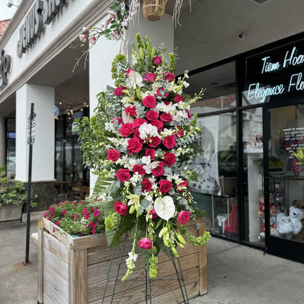 Tall floral standing arrangement with pink roses and white blooms