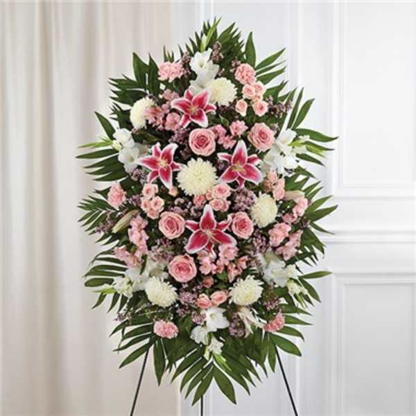 Tall pink and white standing spray with lilies, roses, carnations, and mums on an easel