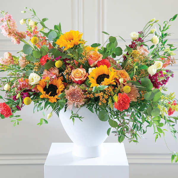 Colorful mixed flower arrangement in a white vase