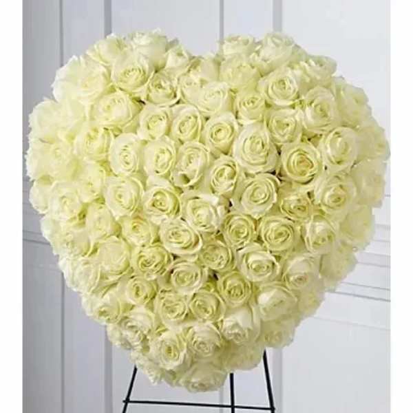 Heart-shaped arrangement of ivory roses on a standing easel