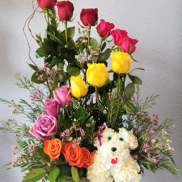 Mixed rose arrangement with a white dog-shaped floral figure
