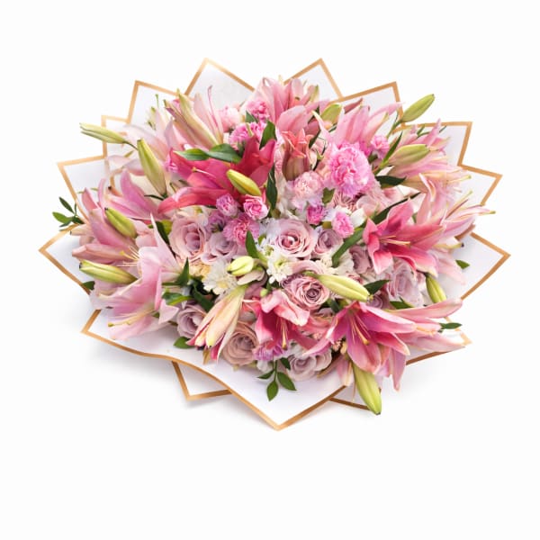 Pink bouquet of lilies and roses wrapped in white paper
