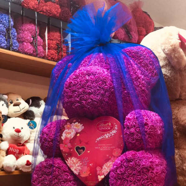 Heart-shaped rose gift with chocolates and blue tulle wrap