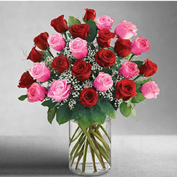 Bouquet of red and pink roses in a clear glass vase