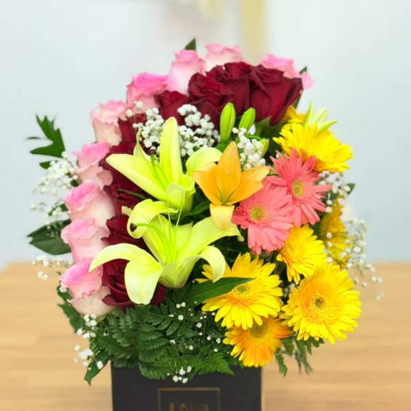 Mixed bouquet of roses, lilies, and gerbera daisies in a black box