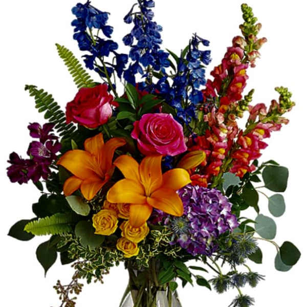 Colorful bouquet of roses, lilies, and mixed blooms in a glass vase