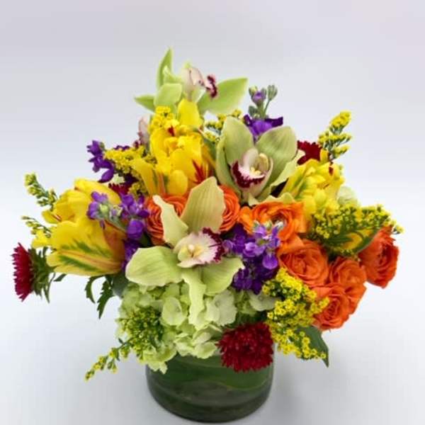Colorful mixed bouquet in a green glass vase