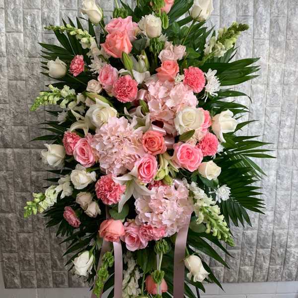 Standing floral spray with pink and white roses and carnations
