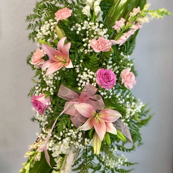 Tall floral standing spray with pink lilies, roses, and carnations