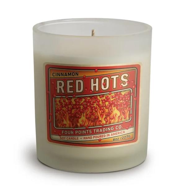 Frosted glass candle jar with a red cinnamon label