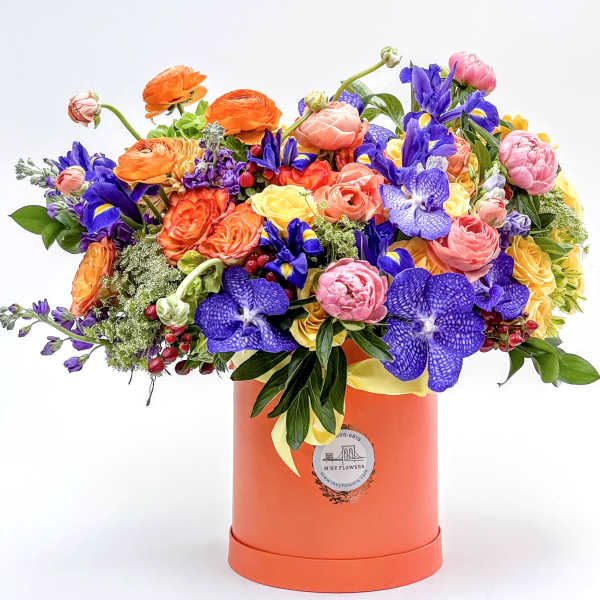 Colorful mixed bouquet in an orange hat box