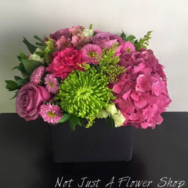 Pink and purple bouquet with a bright green chrysanthemum in a black box