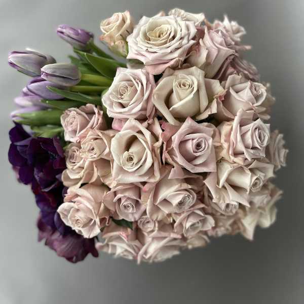 Bouquet of pale pink roses with purple tulips