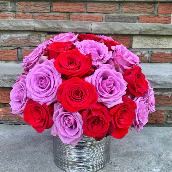 Bouquet of red and lavender roses in a silver vase