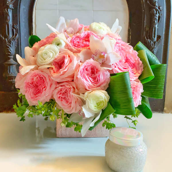 Pink and white rose bouquet with orchids in a square vase