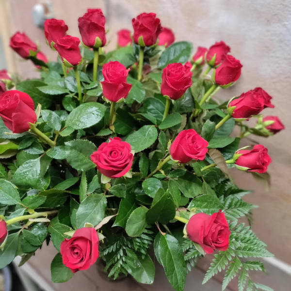 Bouquet of red roses with glossy green foliage