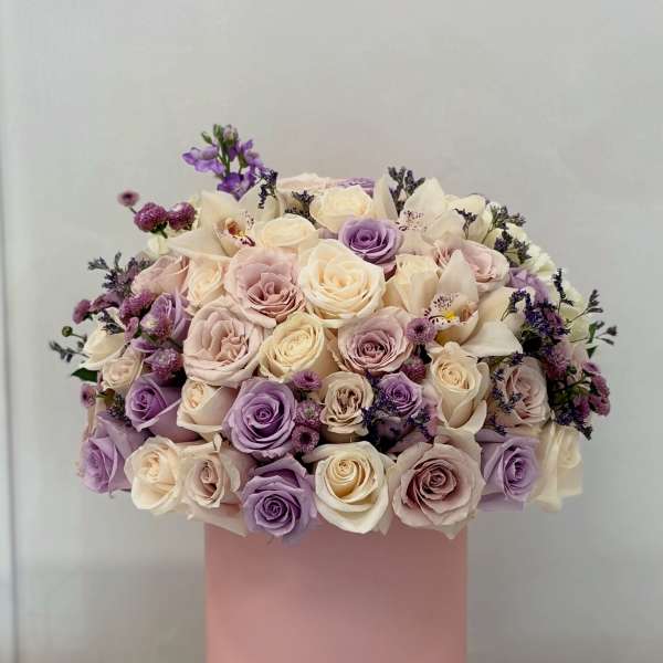 Pastel rose bouquet in a pink cylindrical box