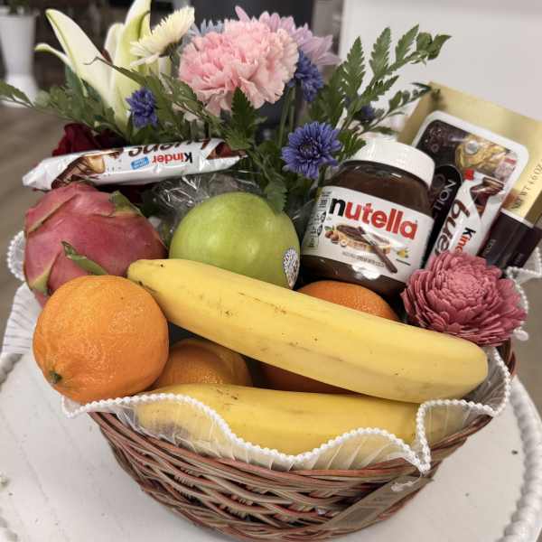 Fruit basket with flowers, chocolates, and a Nutella jar