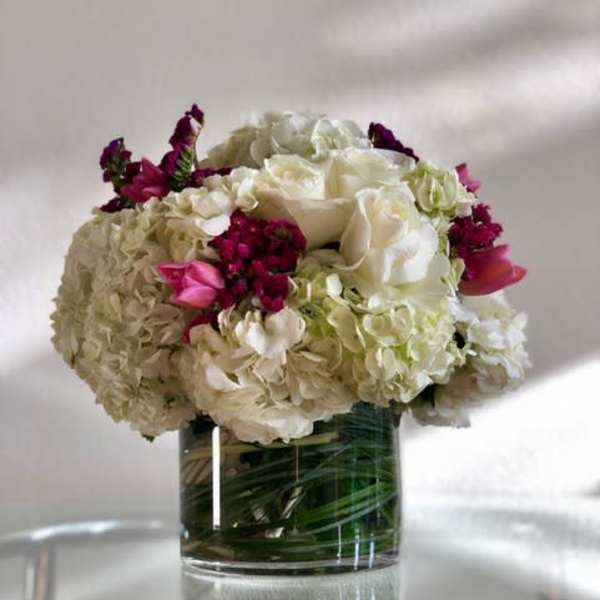 White and pink floral arrangement in a clear glass vase