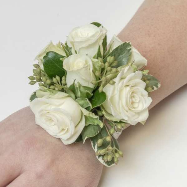 White rose wrist corsage with green accents
