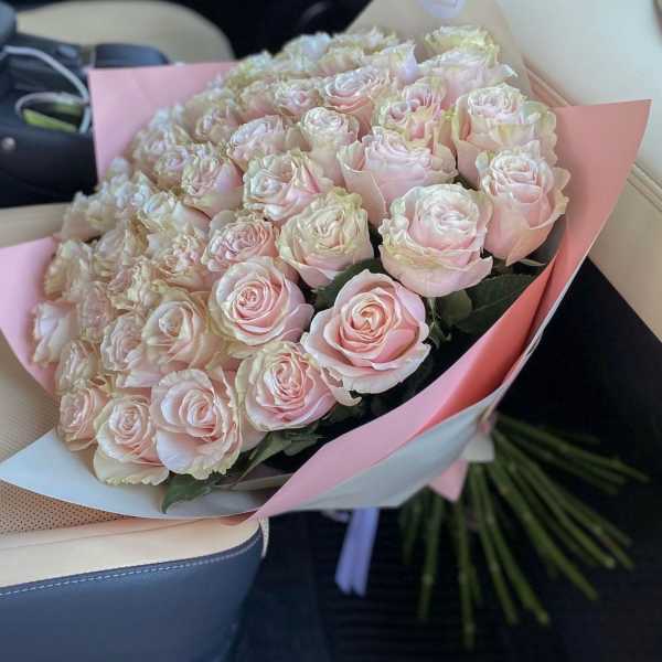 Bouquet of pale pink roses wrapped in pink paper