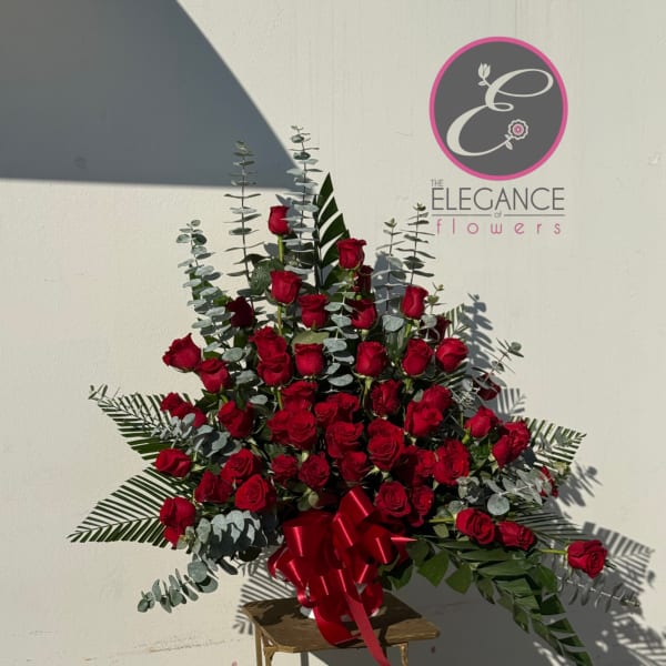 Large bouquet of red roses with eucalyptus and a red ribbon on a stand
