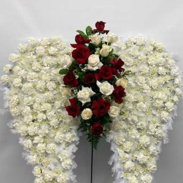 Standing floral spray with red and white roses surrounded by white flowers
