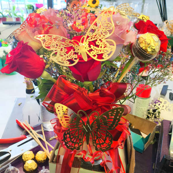 Bouquet of red roses with butterfly decorations and ribbon