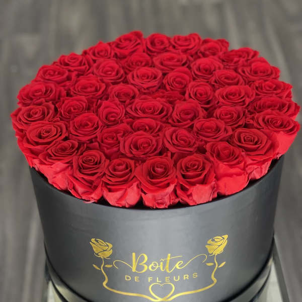 Round box filled with red roses
