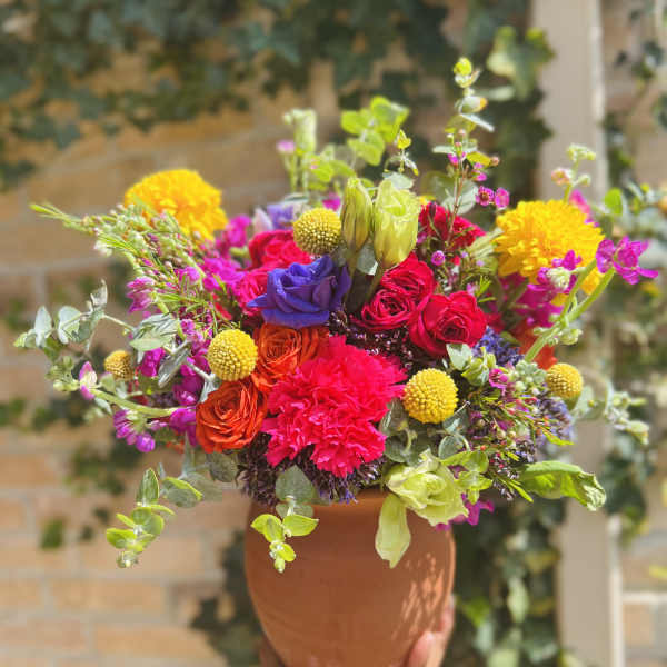 Colorful mixed bouquet in a terracotta vase