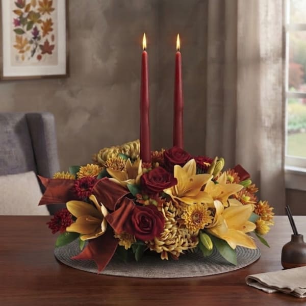 Autumn floral centerpiece with two red taper candles