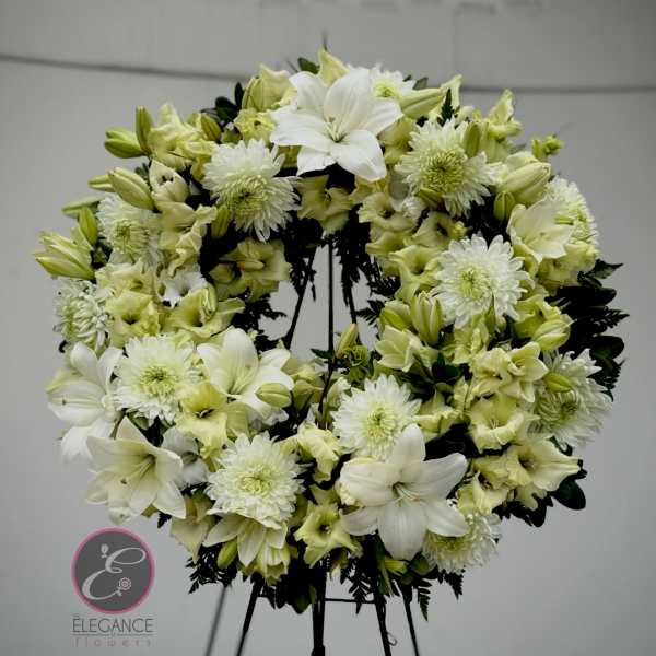 White and pale green floral wreath on a stand