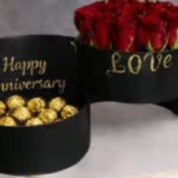 Black gift boxes with red roses and gold chocolates