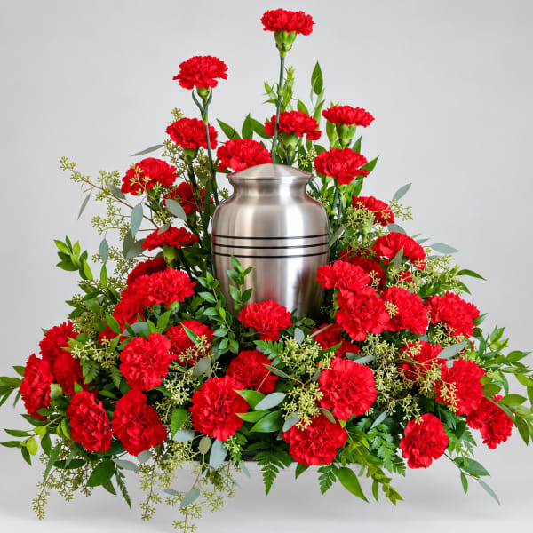 Red carnations arranged around a silver urn