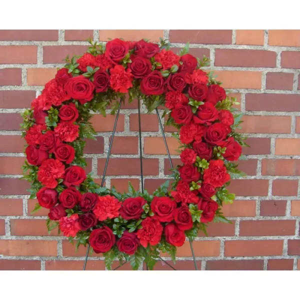 Red rose and carnation wreath on a stand