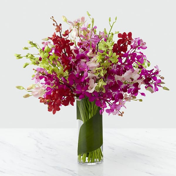 Colorful orchid bouquet in a clear glass vase
