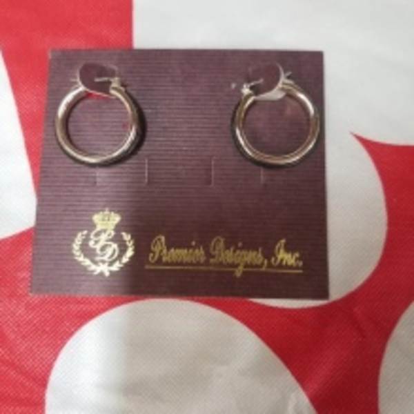 Pair of gold hoop earrings on a branded display card