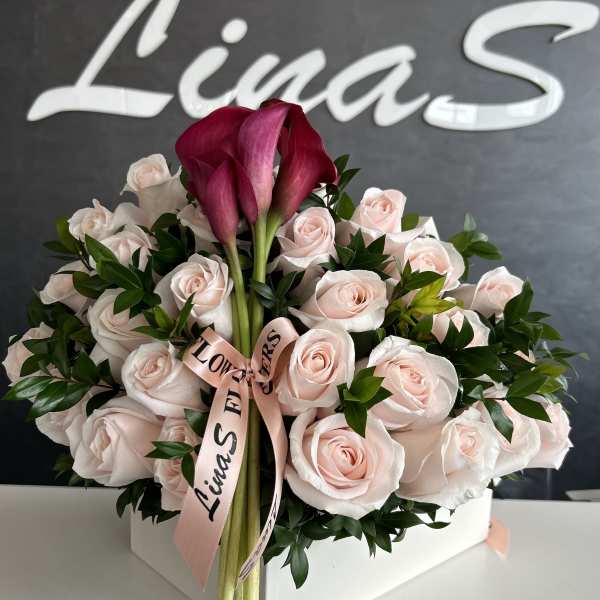 Pink rose arrangement with burgundy calla lilies in a white box