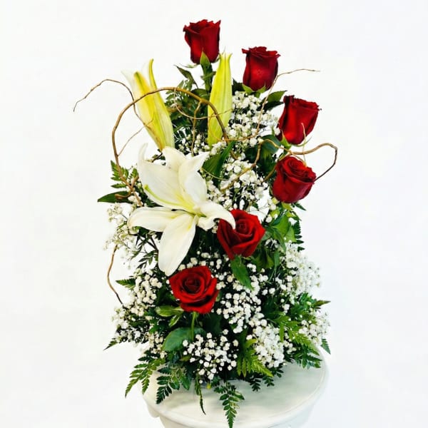 Tall arrangement of red roses and white lilies with baby's breath