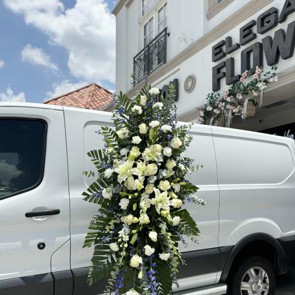 Tall white floral standing spray on an easel